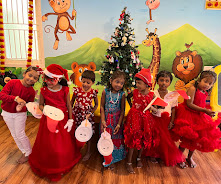 Children in Christmas outfits celebrating Christmas at Mrs Reena's Cocoon Play School